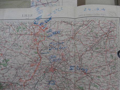 Photograph of a large map of Lille with troop movements and plans drawn across it