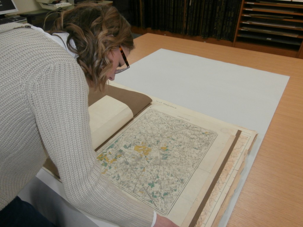 Student Ellie reading through some of the large documents at Kew National Archives